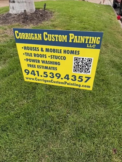 Corrigan Custom Painting LLC yard sign listing houses, mobile homes, tile roofs and stucco