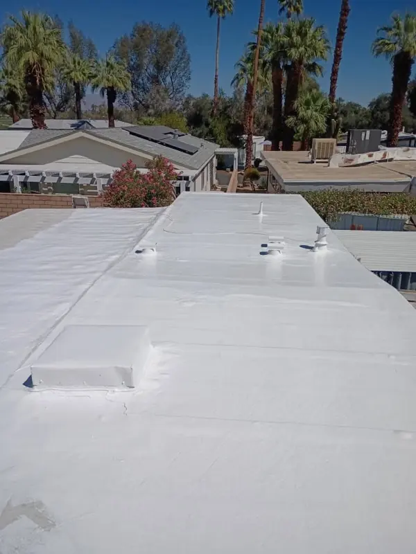Mobile home flat roof after painting in bright white
