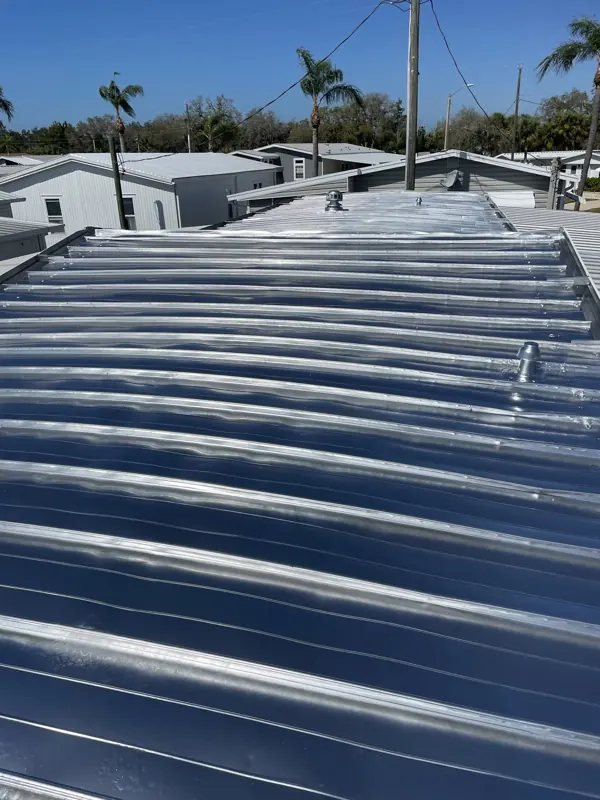 Freshly painted silver metal roof in a mobile home community