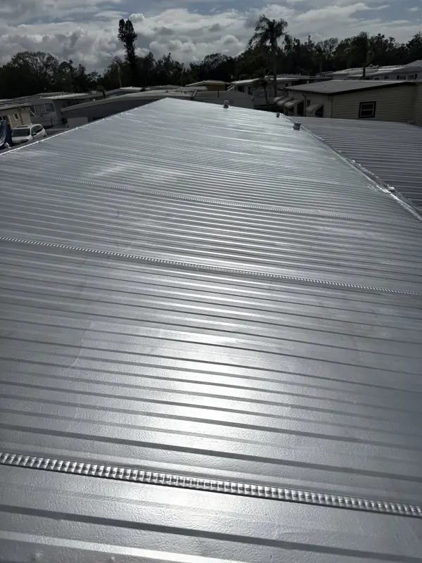 Silver painted metal roof on a mobile home on a sunny day