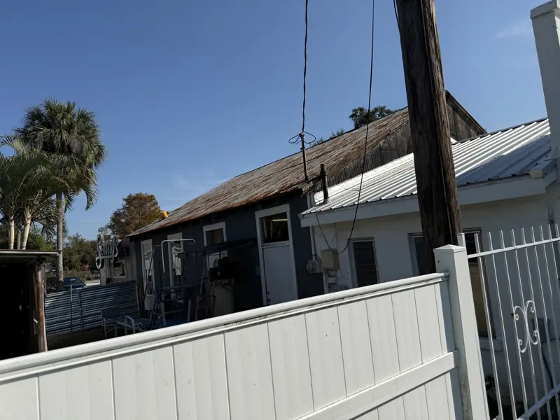 Side view of a metal roof being painted