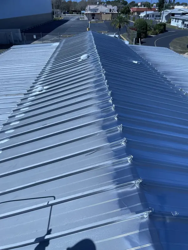 Ridge view of a metal roof after painting silver