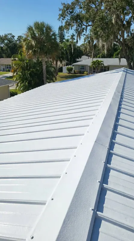 Mobile home metal roof after painting in a bright white finish