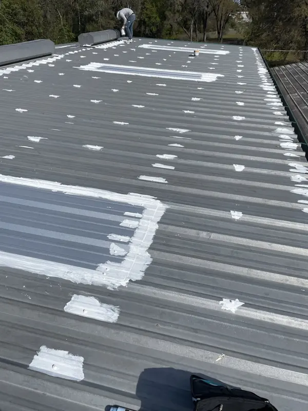 Patched metal roof before painting on a mobile home