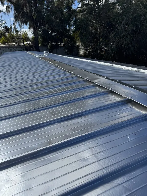 Standing seam metal roof after painting silver
